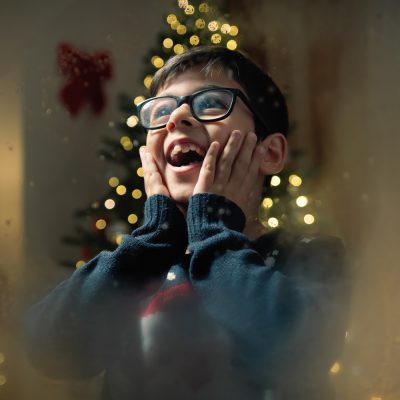 Child amazed by seeing santa On Christmas night.